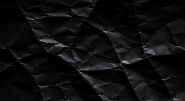 Black crumpled paper texture background photo