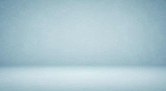 An empty room with a blue wall and a white floor photo