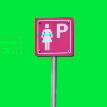 Bright Pink Women's Parking Sign on Vibrant Green Background for Modern Urban Design Concepts photo