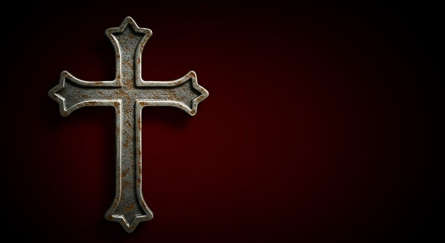 A rusty cross on a red background photo