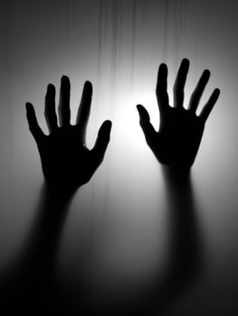Hands pressed against a translucent surface creating shadows photo