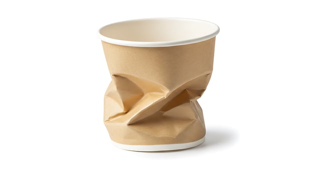 A paper cup with a brown wrapper on it photo