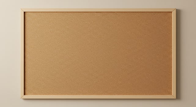 A blank cork board on a wall photo