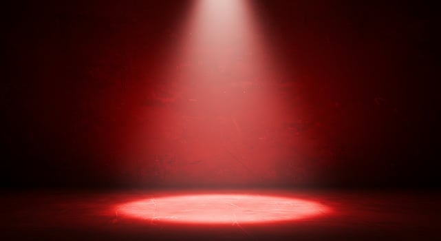 Red spotlight on a dark room with a red wall photo