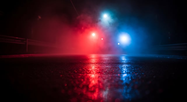 A red and blue light shining in the dark photo