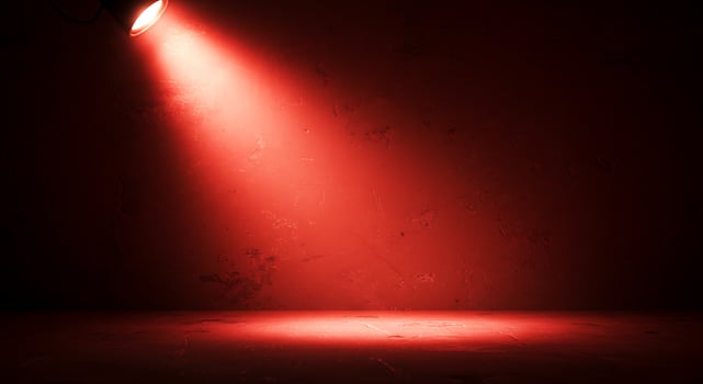 Red spotlight on a dark wall with a red floor photo