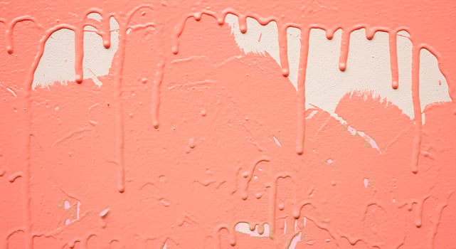 A pink wall with paint dripping down it photo
