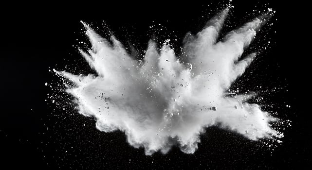 White powder exploding on a black background photo
