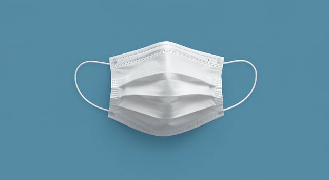 White surgical mask on blue background photo