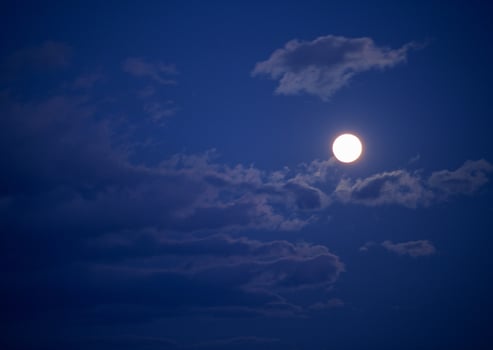 the moon is shining brightly in the sky photo