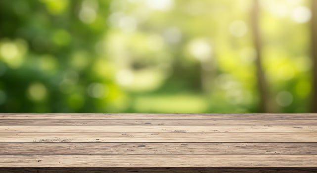 Empty wooden table top over blurred green background photo