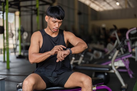 Fitness and Technology. Man Monitoring Workout Progress photo