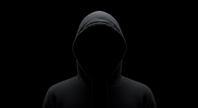 A person in a hoodie on a black background photo