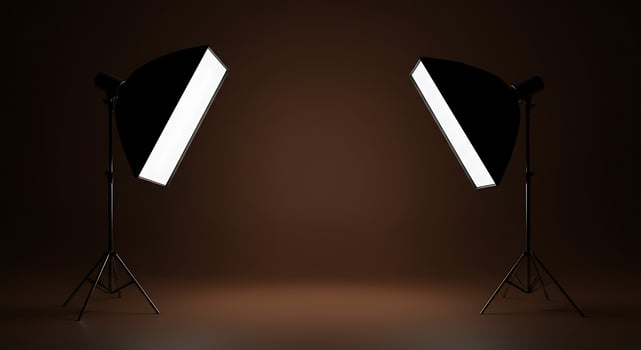 Two light stands with a spotlight on a dark background photo