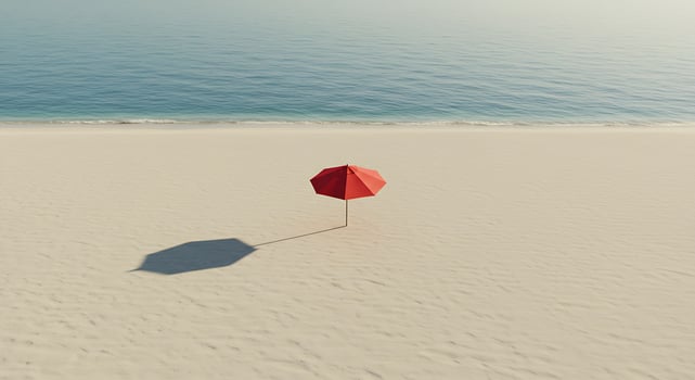 A red umbrella on a sandy beach photo