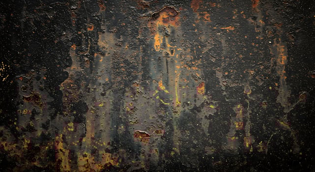 A rusty metal surface with paint and rust photo