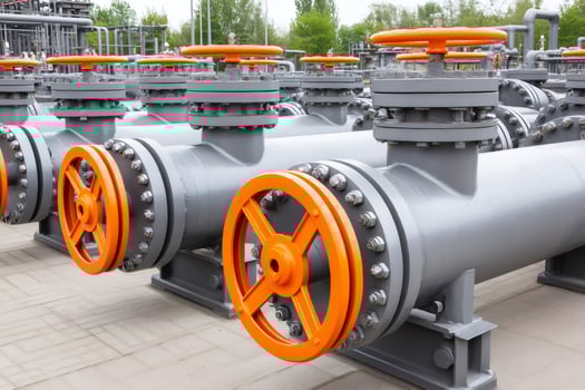 Industrial pipes with valves controlling flow in a modern refinery photo