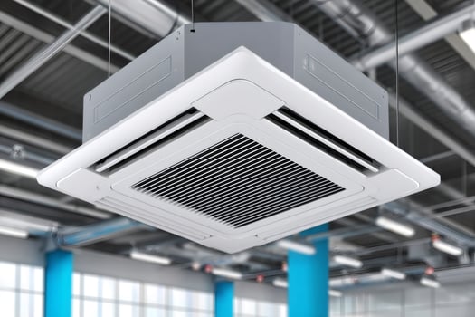 Modern ceiling mounted cassette type air conditioner unit cooling a room photo