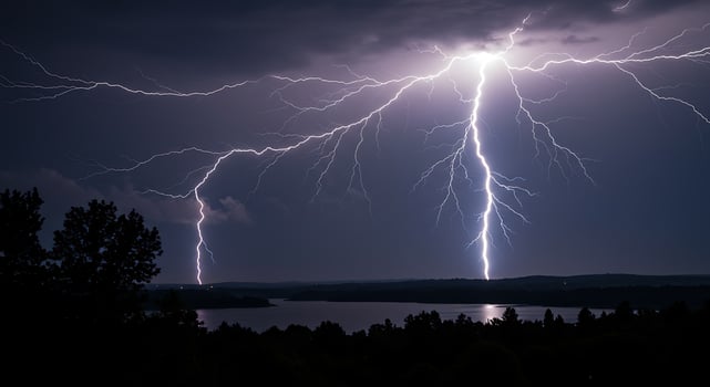 Lightning strikes over a lake and trees photo
