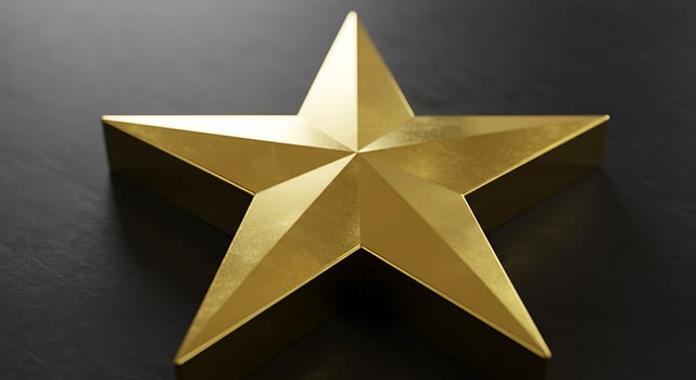 A golden star on a black surface photo