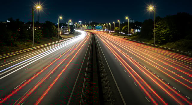 A highway with cars driving on it at night photo