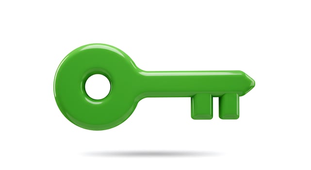 A green key on a white background photo