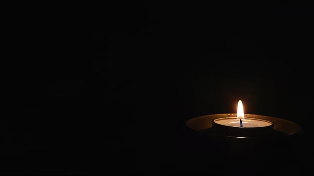Single Candle Flame in Dark Night photo