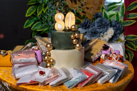 a cake with a number 80 on it and a bunch of gifts photo
