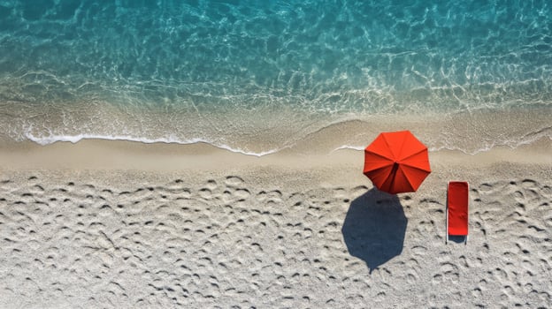 Red Umbrella and Beach Towel on Sandy Shore photo