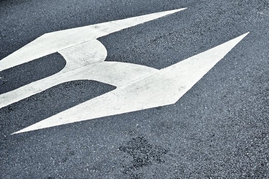 White Arrow on Grunge Concrete Wall Background. photo