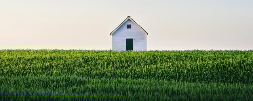 Lonely white house amidst a vast green field under a clear sky. Natural fresh and clean, pure crisp air in countryside, mist concept. photo