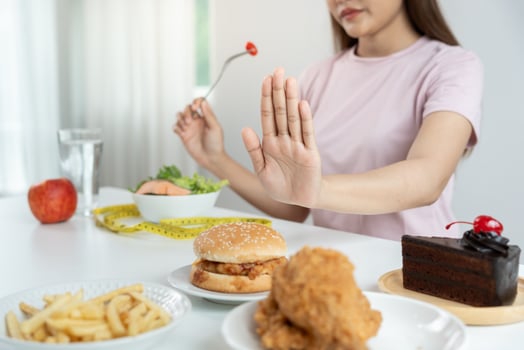 slim body Women choose healthy foods and junk food, female choose salad for diet. Good healthy food. weight lose, balance, control, reduce fat, low calories, routines, exercise. photo