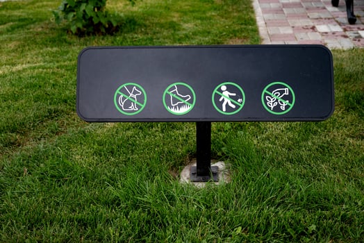 Park sign with prohibitions on activities in green area. photo