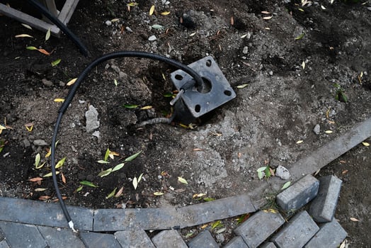 New electric cable in the ground. Border ruler. photo