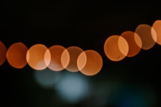 Warm glowing bokeh lights on dark background for festive concepts photo