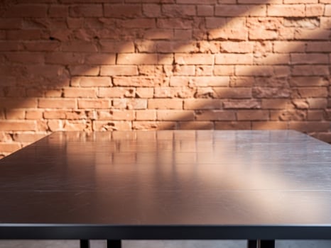 Table surface against brick wall background with sunlight, indoor composition. photo