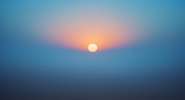 Solitary Sun. A Serene View of the Sunset Sky with Subtle Color Gradients. photo