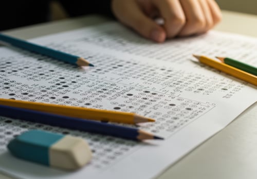 A close up shot reveals the filled answer sheet with colorful pencils scattered around. photo