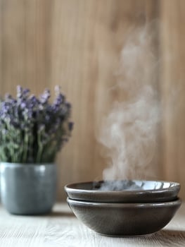 Tranquil spa scene with steaming herbal compress and lavender for relaxation photo