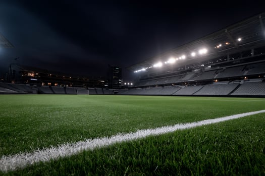 A soccer field at night with lights on photo