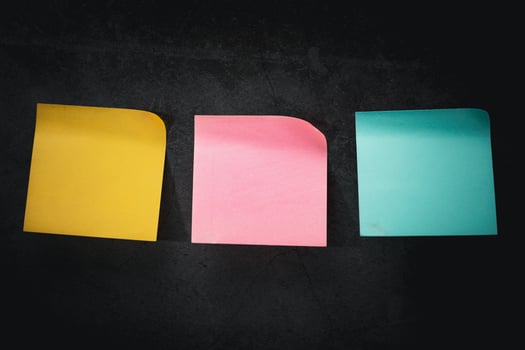 Colorful Post-it Notes Stuck on a Dark-Toned Background photo