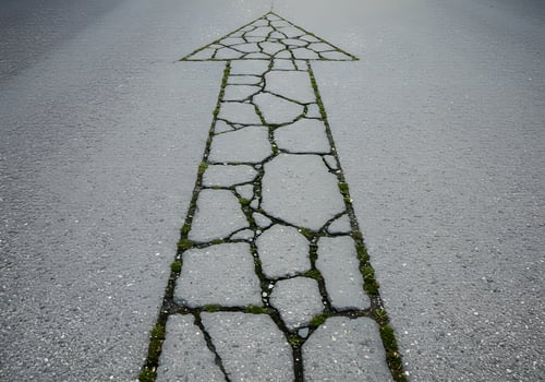 Upward arrow on cracked paving photo