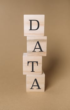 Stack of wooden blocks with the letters DATA on top photo