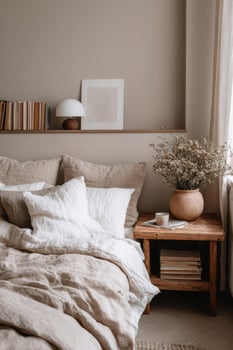 A bed with a white comforter and a vase of flowers photo