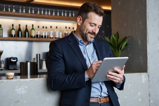 A man in a suit is using a tablet computer photo
