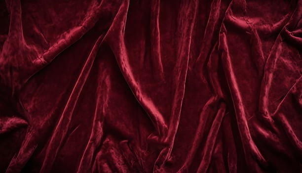 Luxurious red velvet fabric draped in soft folds showcasing plush texture photo