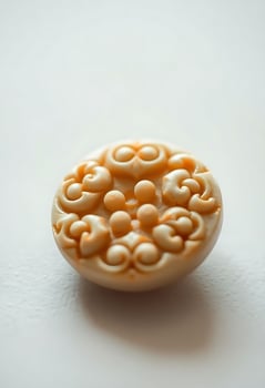close up of a button on a white surface photo