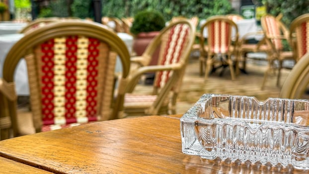 Empty vintage cafe terrace, wicker chairs whisper stories, awaiting La Tomatinas vibrant chaos or quiet Yule reflections photo