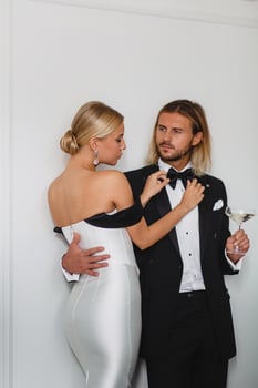 Seductive young bride and bridegroom posing in hotel room photo