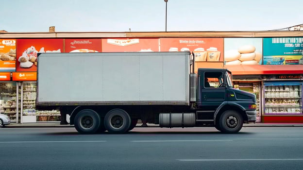 Delivery truck parked on bustling street near shops in midday light photo